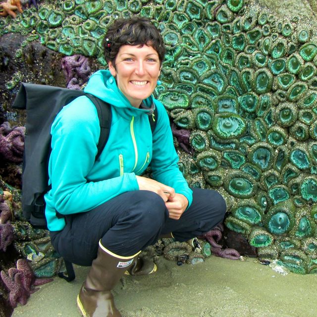Nature United's BC marine lead poses with a colony of sea anemones.