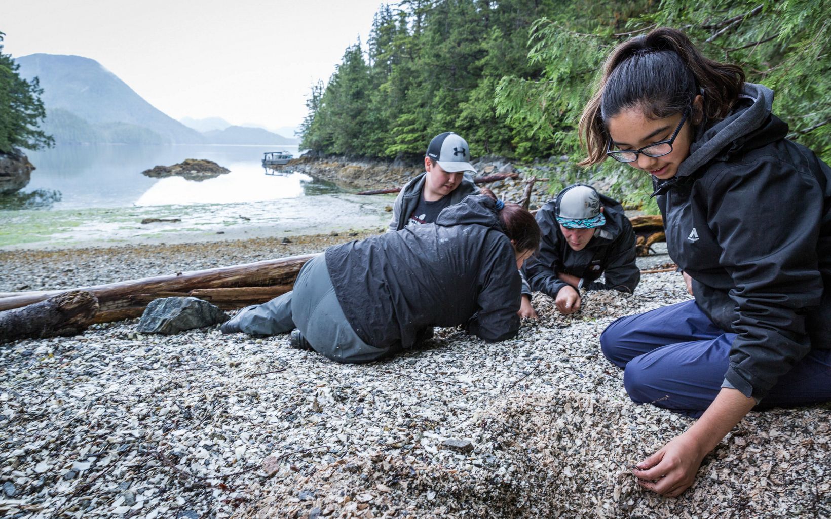 SEAS interns dig through an ancient shell midden site looking for artifacts in the Kitasoo/Xai'xais Nation of the Great Bear Rainforest.