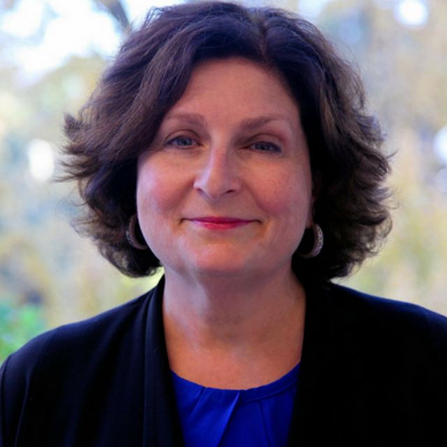 headshot of a white woman with dark hair