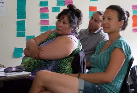 Group of people listens to a presentation
