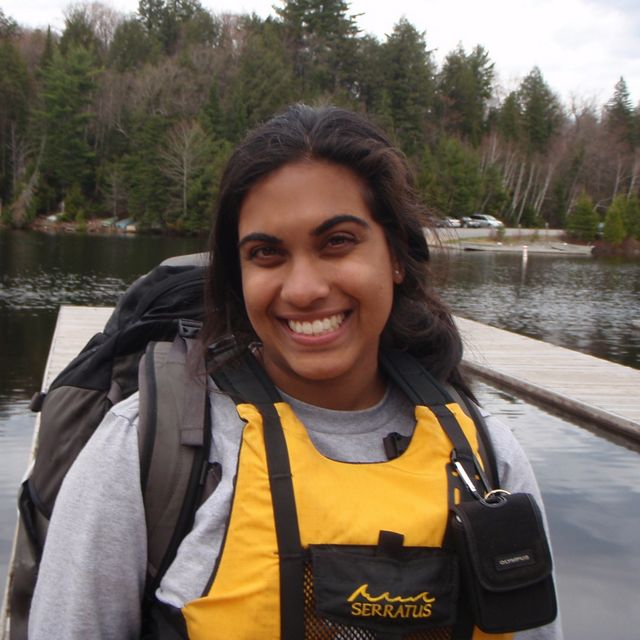 a woman in a lifejacket smiling at the camera