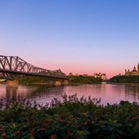 View of downtown Ottawa and the Parliament Buildings of Canada at sunset, taken from Gatineau, Quebec across the Ottawa River