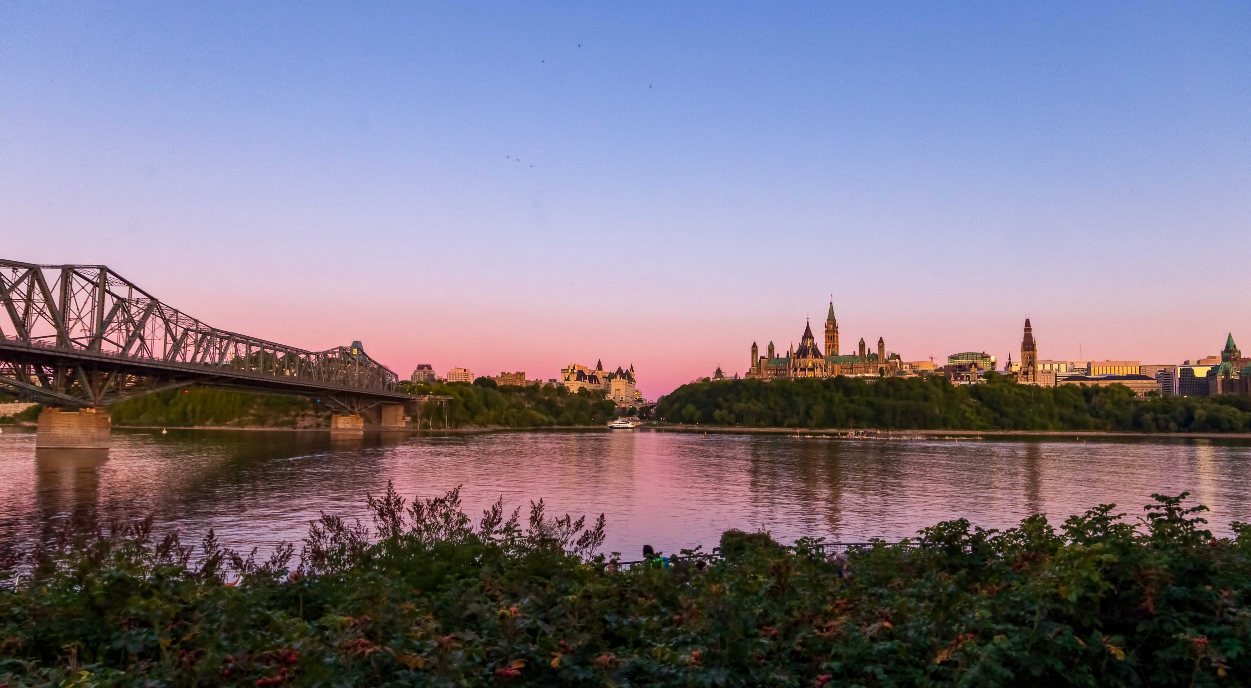 View of downtown Ottawa and the Parliament Buildings of Canada at sunset, taken from Gatineau, Quebec across the Ottawa River