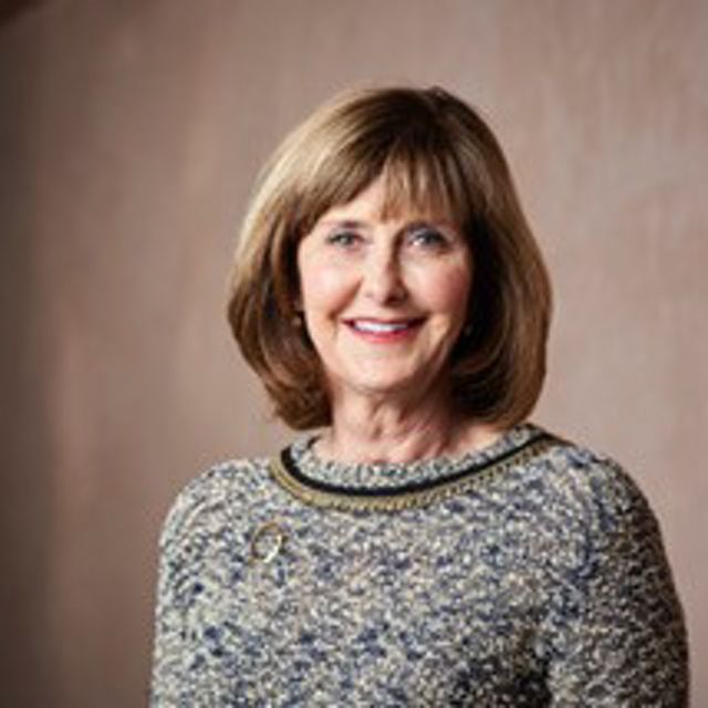 Headshot of Susan Millican in a gray suit