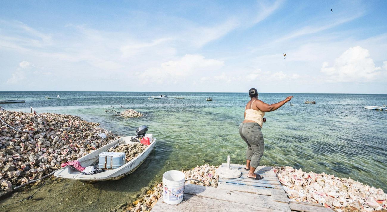 Women fishing on the shore.