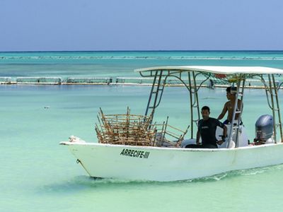 men fishing on a boat.