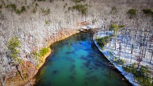 Snow covers along a riverbend.