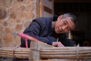 Lao Zhong looking at his crossbow.