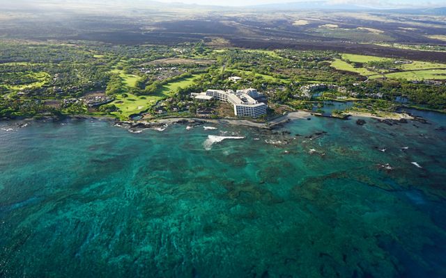 Aerial view of a large resort hotel along the Kona Coast, which is protected by huge coral reefs.