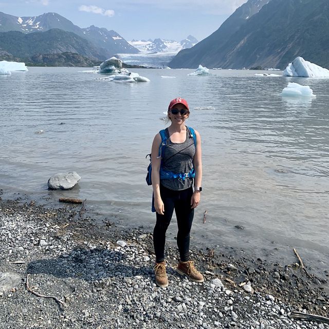 Dr. Hannah Birge standing in front of a glacier.