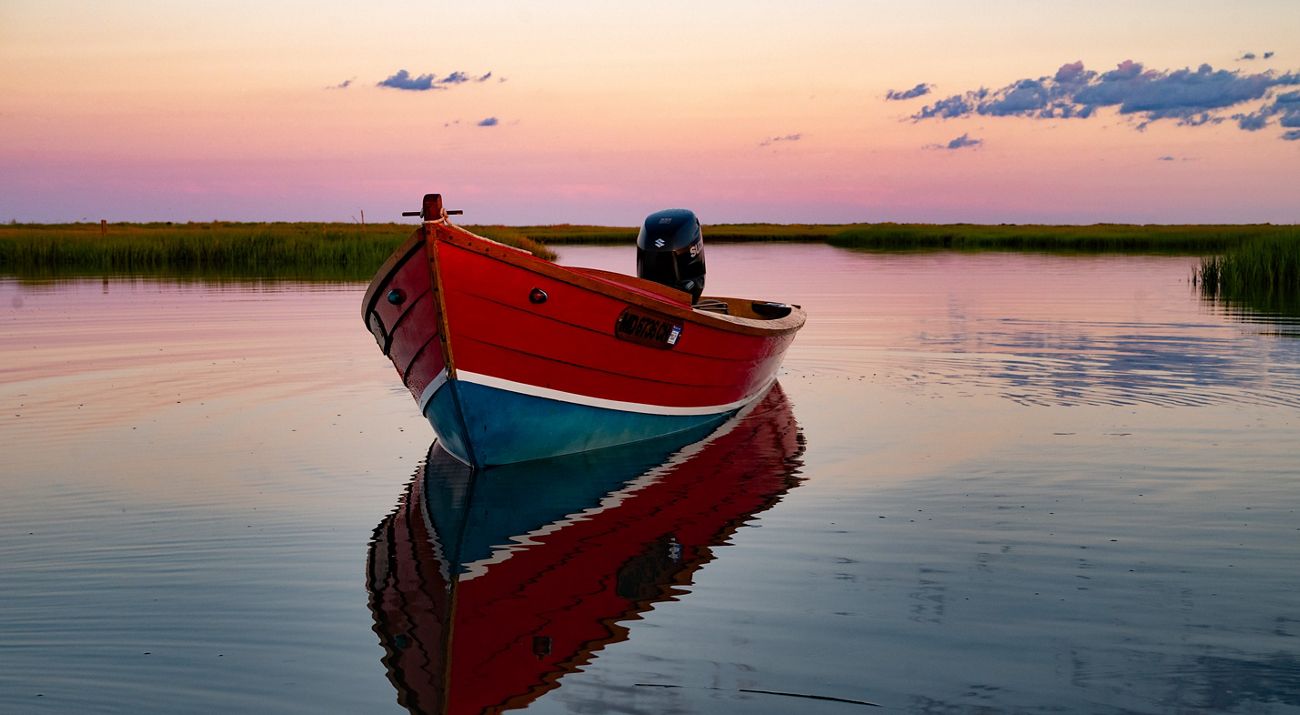 Skiff off Cedar Island at sunset.