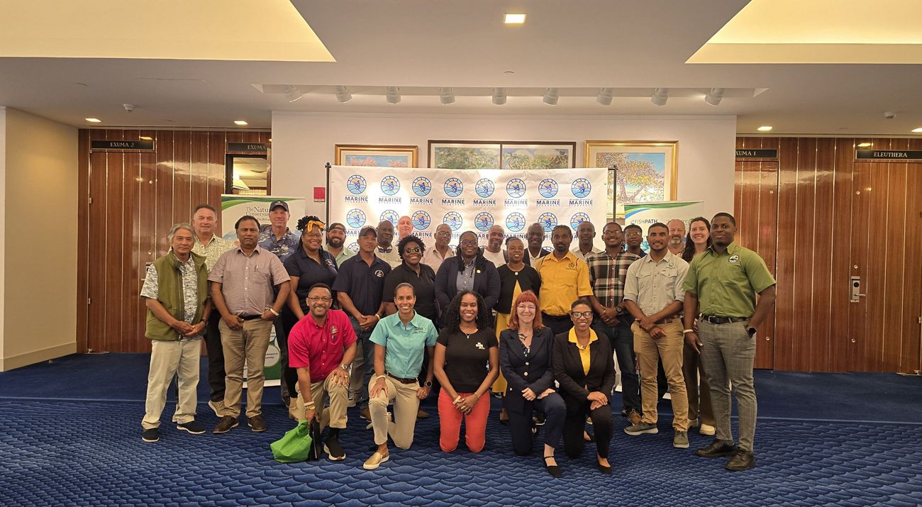 A group of people gather for a photo at a meeting.