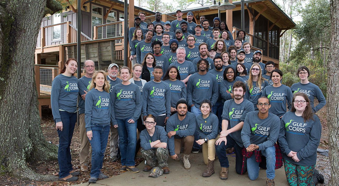 A group of people wearing blue shirts pose for a picture.