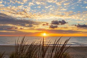 The sunrises over the Delaware Bayshore creating a vibrant sky.