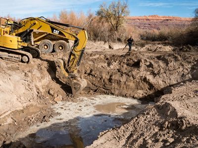 Digger widening a river channel.