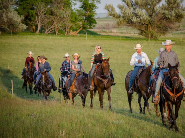 The Doan Family (ten people) on horses riding through a pasture.