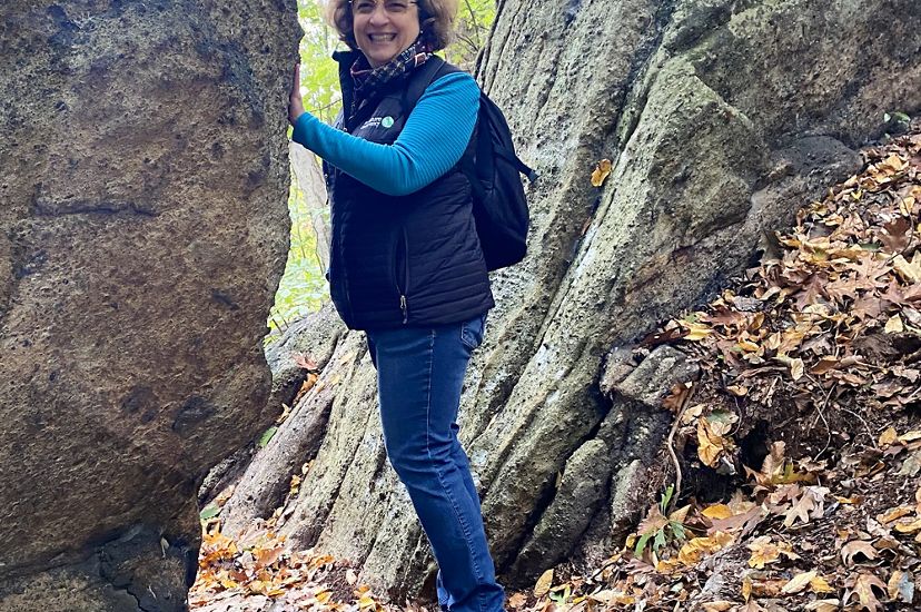Candid photo of deputy executive director Donna Bowers on a hiking trail. 