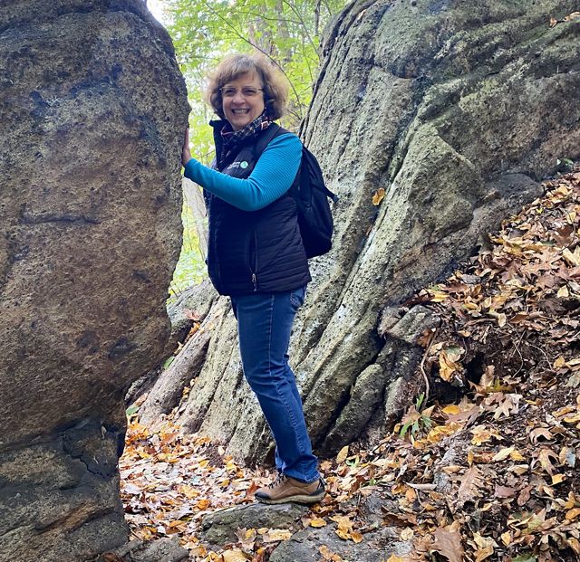 Candid photo of deputy executive director Donna Bowers on a hiking trail. 