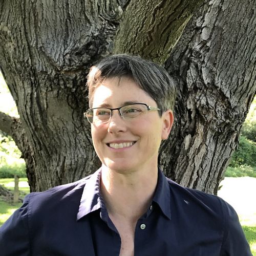 Headshot of Donnelle Keech in front of a large tree