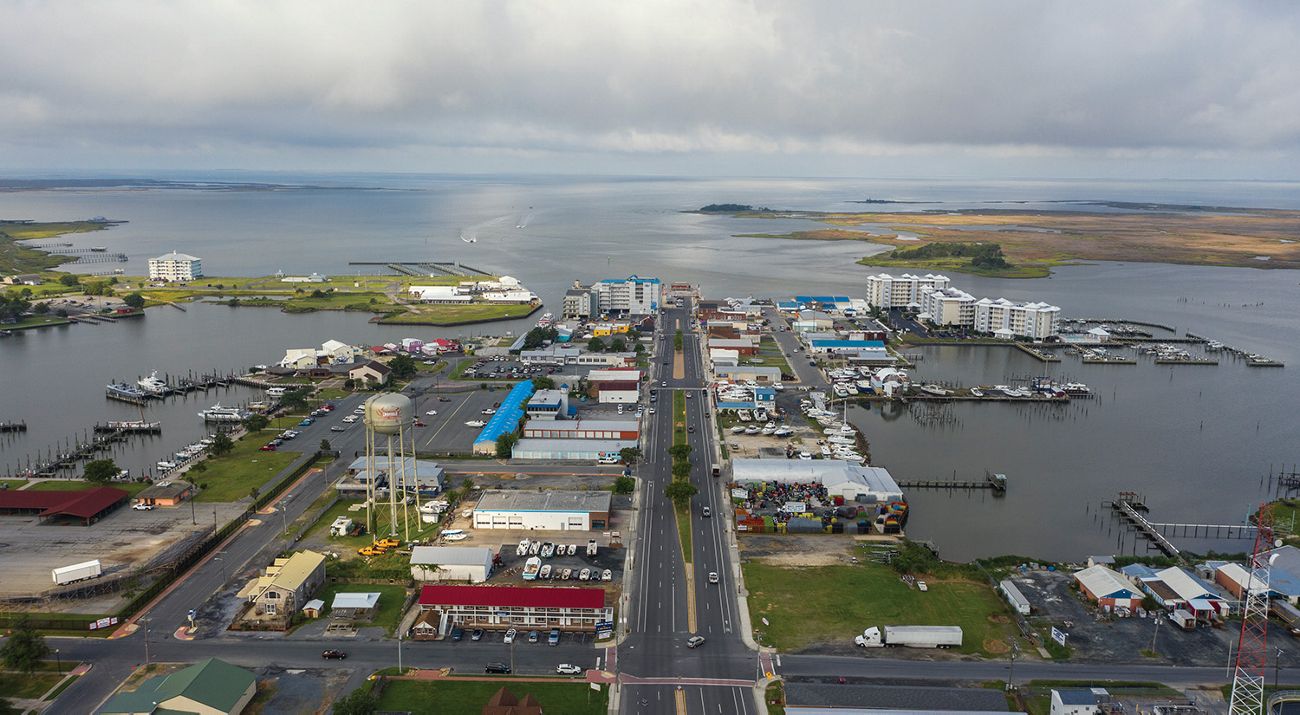A road goes through a main street that is surrounded by water on all sides.