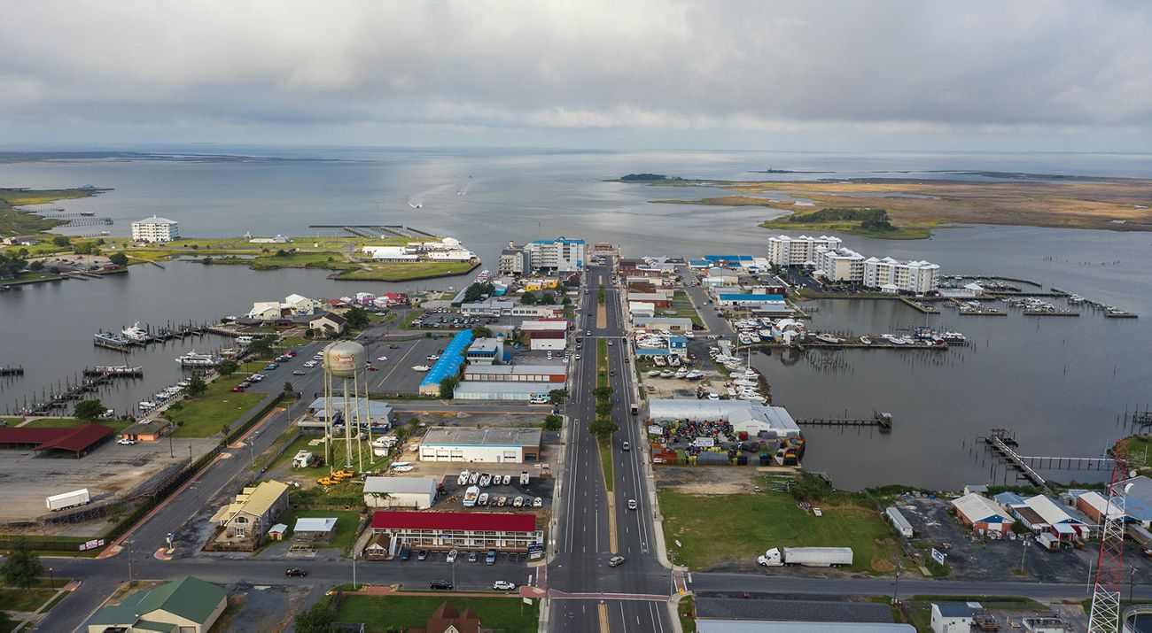 A road goes through a main street that is surrounded by water on all sides.