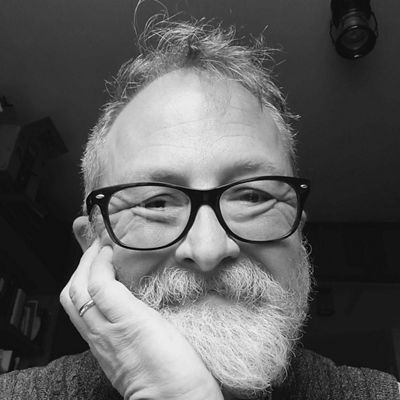 A black and white close-up selfie of poet Doug Van Gundy.