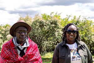 A father and daughter stand together.