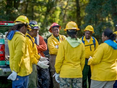 A group of Job Corps fire training students gather to listen to instructors
