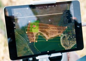 A small screen shows an aerial map of the site.