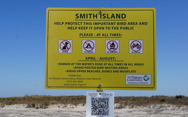 A large yellow sign on Smith Island warns visitors of sensitive nesting areas nearby.