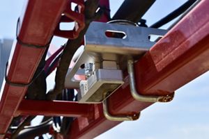 A close-up image of the AI device attached to a red tractor