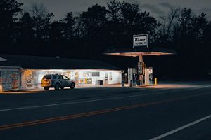 A view of a gas station in the evening light. 