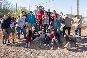A group of volunteers pose after completing a tree planting event in Phoenix, AZ.