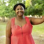 Candid headshot of Vanessa Moses taken outdoors on the grounds of Brownsville Preserve.