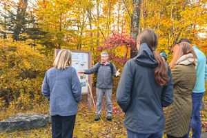 A group of people take a guided tour at Tannersville Cranberry Bog.