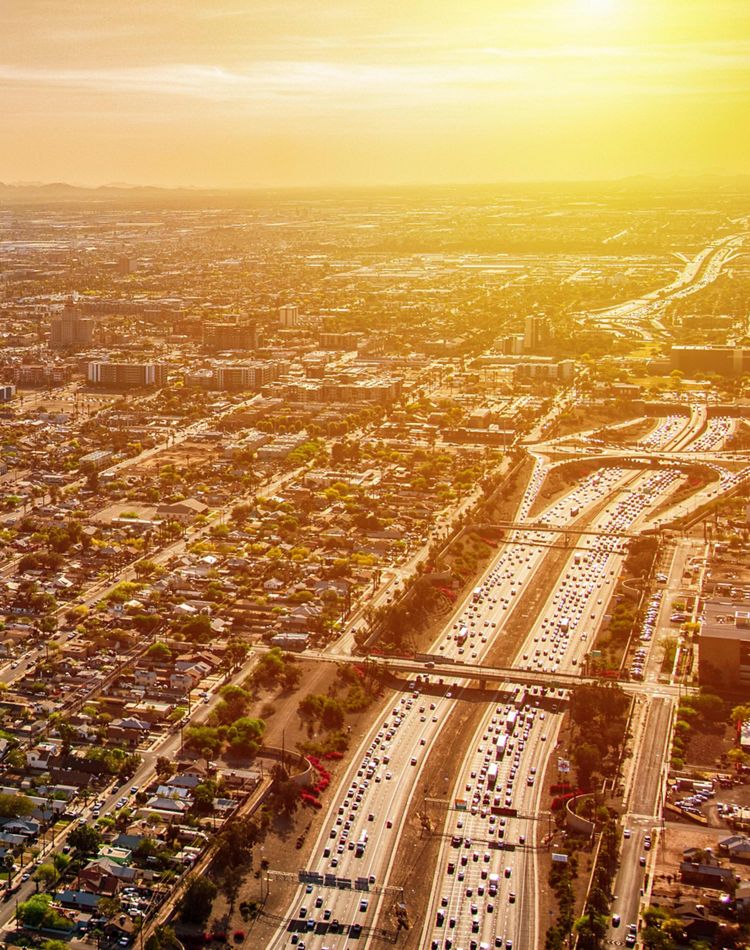 Aerial of downtown Phoenix at dusk, with highways