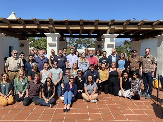Participants of the NASA-UCSB-PCI Project SHIFT science meeting gather on a building patio for a group photo.