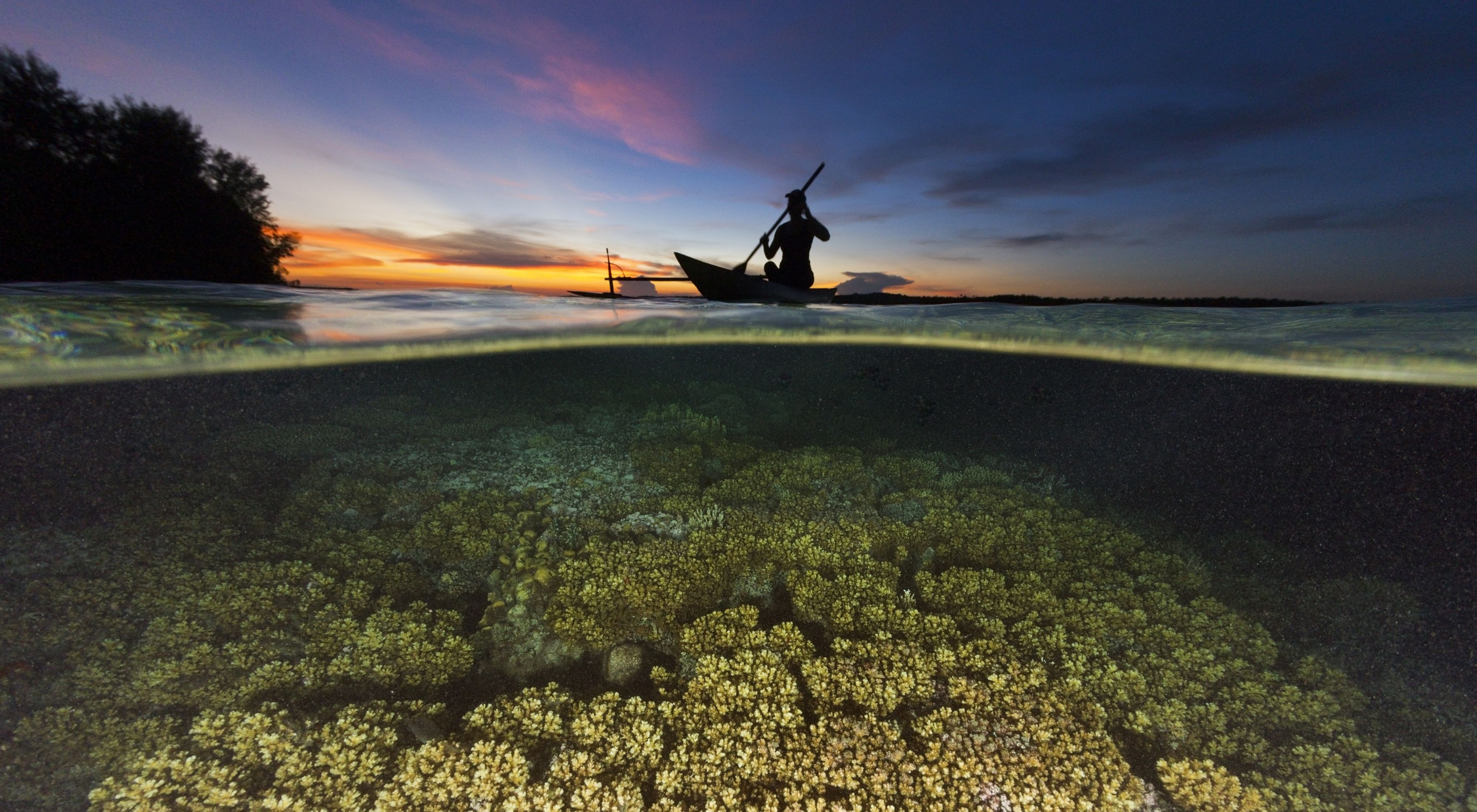 Daybreak over a coral reef in Papua New Guinea.