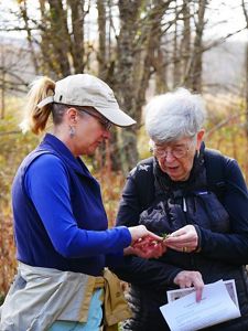 Travel and staff engaged in a botany lesson on a Discover with Nature trip to Tennessee.