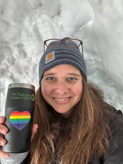Christine Kessler sitting inside an igloo.
