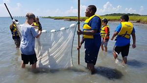 TNC's VVCR Education Program participants wear life jackets while working together in the water on the Eastern Shore. 