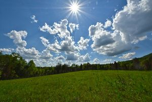 large fluffy clouds scattered across a sunny sky