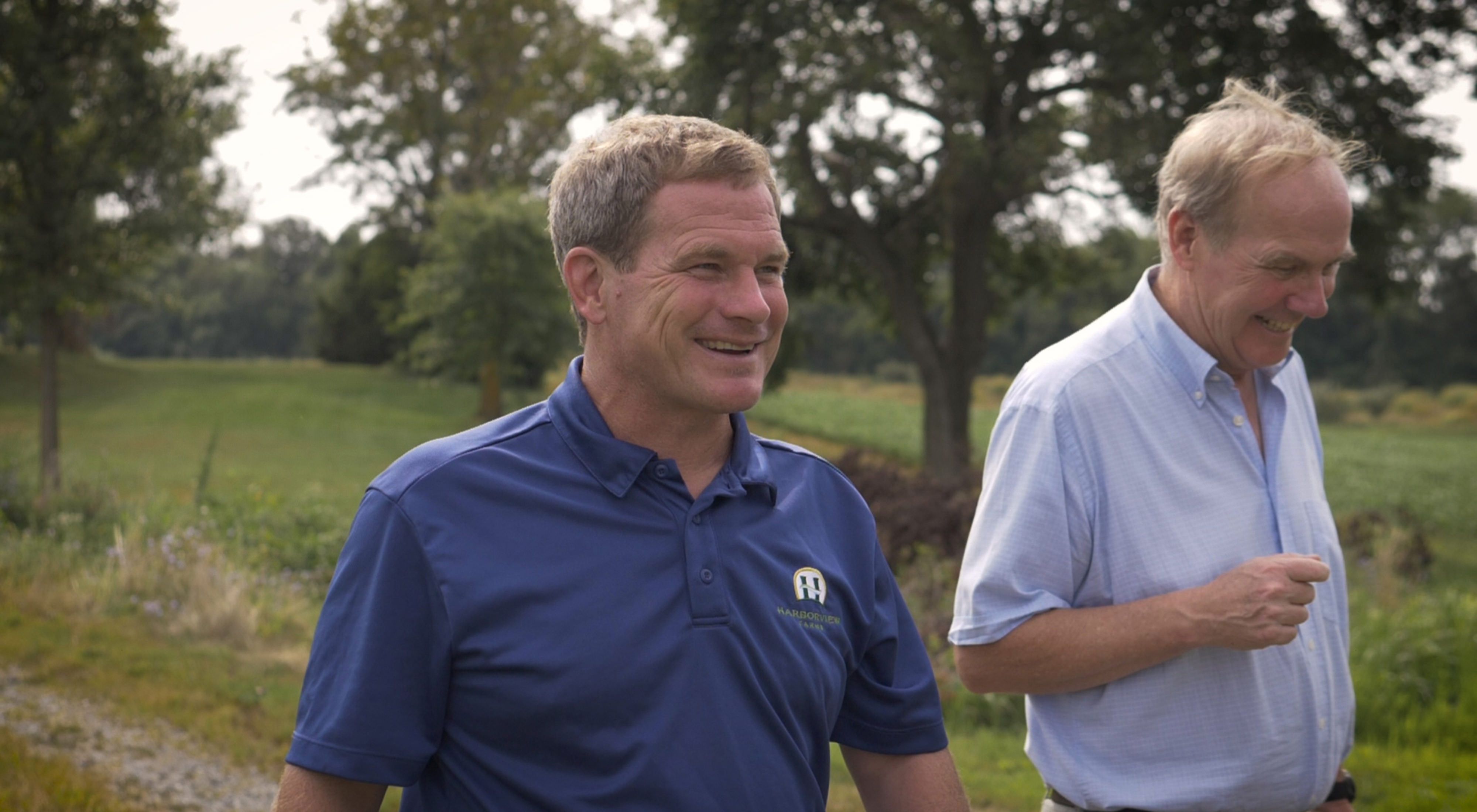 Farmer Trey Hill (left) and landowner Joe Hickman (right) discuss the importance of conservation on Joe’s farmland.