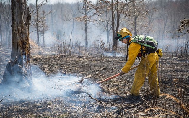 A fire fighter administers a controlled burn in Kentucky.