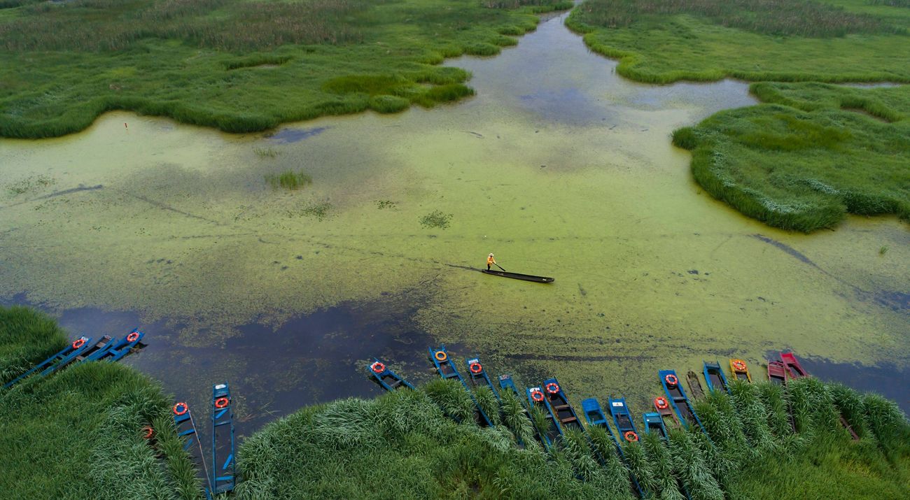 A fisher in a canoe, Yunnan Province, China.