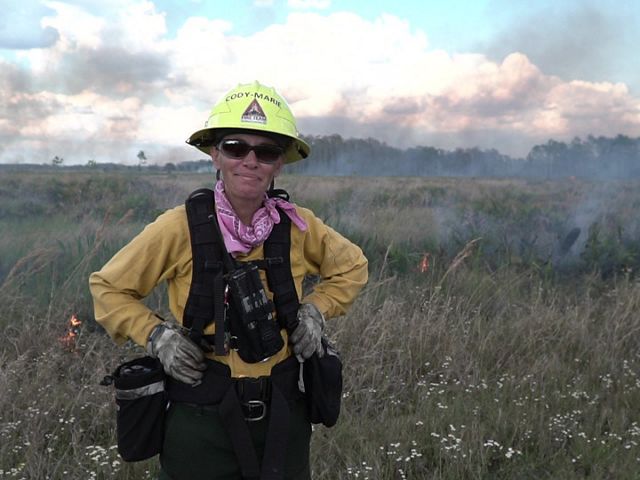 Cody-Marie Miller in fire gear at a controlled burn.