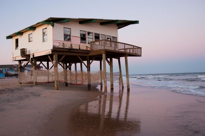 An endangered house in wait of advancing sea level and coastal storms along the Gulf Coast near Freeport, Texas.