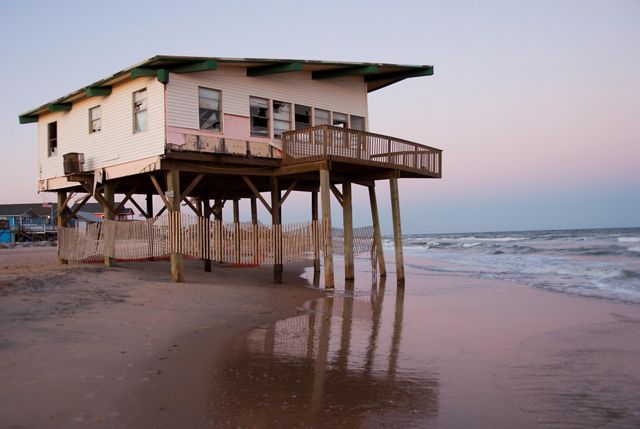 An endangered house in wait of advancing sea level and coastal storms along the Gulf Coast near Freeport, Texas. 