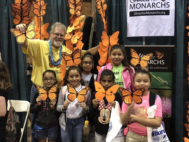 Kids and teachers decorate paper monarch butterflies with TNC and Okies for Monarchs during the Wildlife Expo in Guthrie in September.