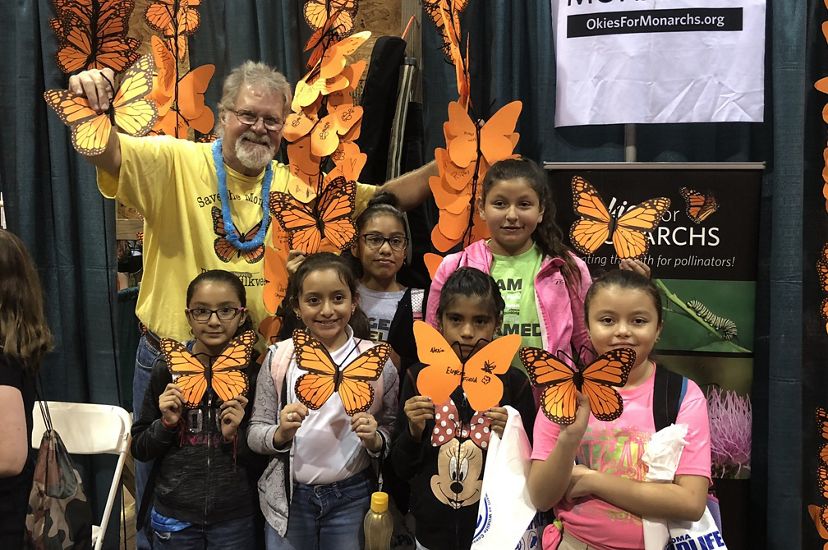 Group of young girls holding their decorated monarch butterflies. 